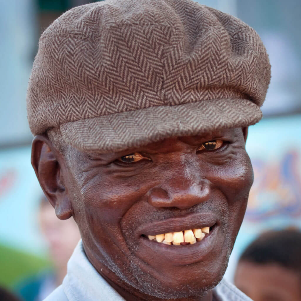 African man with a beret smiling